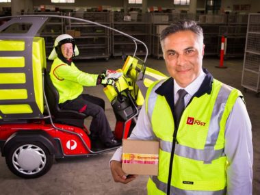 Australia Post Managing Director and Group CEO Ahmed Fahour and Postal Delivery Officer Ron Previllian with the new electric delivery vehicle. Supplied.