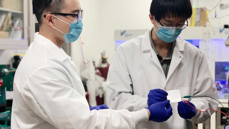 PhD candidates and lead authors Hansen Wang, left, and Zhiao Yu, right, testing an experimental cell in their laboratory.