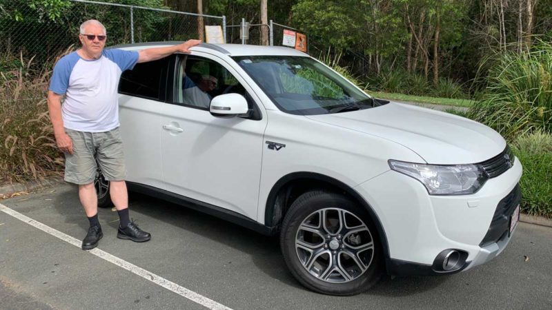 John Poxon with his Mitsubishi Outlander PHEV. Supplied