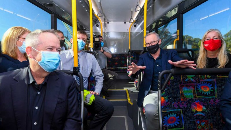 Opposition Leader Anthony Albanese (centre right) and shadow NDIS Minister Bill Shorten sit on an electric bus while visiting Swan Transit Joondalup bus depot. (AAP Image/Lukas Coch)