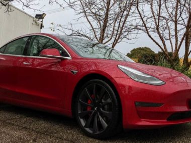 tesla model 3 in the rain