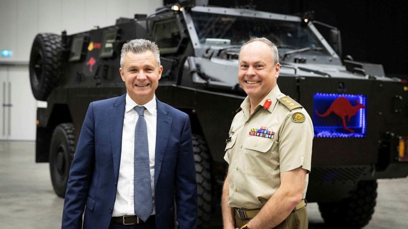 Colonel Robin Smith and Matt Thistlethwaite, assistant minister for defence veterans’ affairs, and the Republic during the Chief of Army Symposium 2022 in front of an all-electric Bushmaster Protected mobility Vehicle. Source: Department of defence