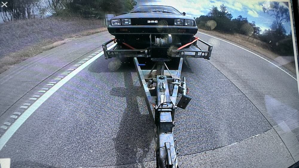 Tesla Model X towing all-electric Delorean