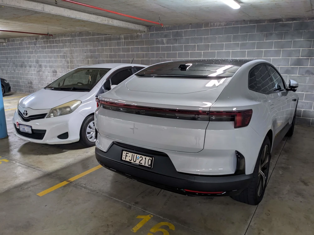 The Polestar 4 looks massive parked next to a Toyota Corolla hatch. Image: Tim Eden