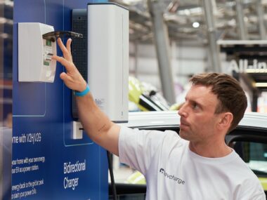 Man flipping a switch on an electrical consumer unit
